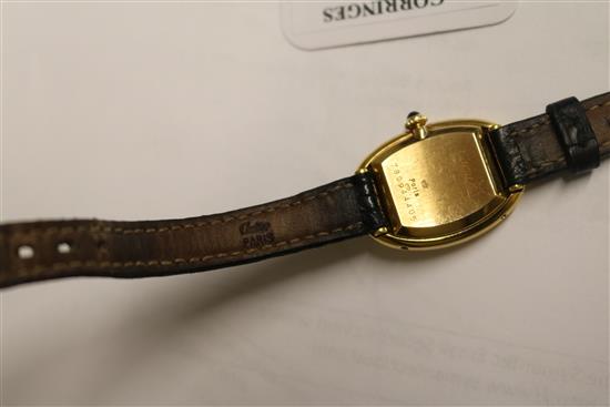 A ladys 18ct gold Cartier oval cased wrist watch, with Cartier box.